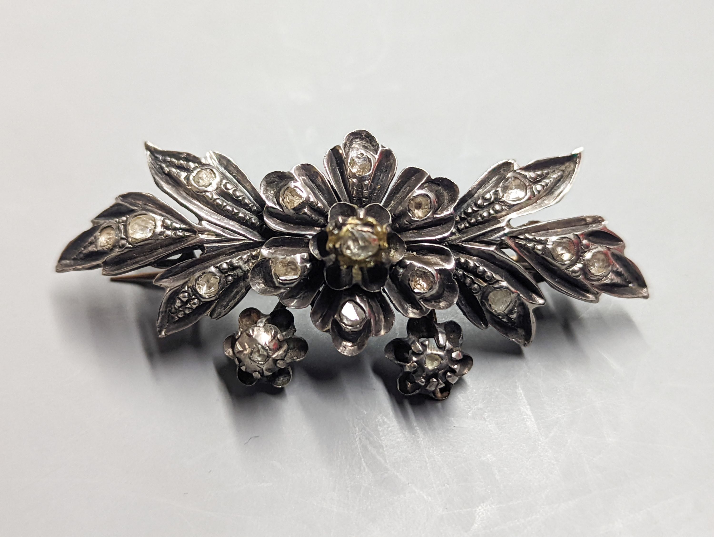 A 19th century continental white and yellow metal , rose cut diamond set floral spray brooch, 71mm, gross weight 21.7 grams.